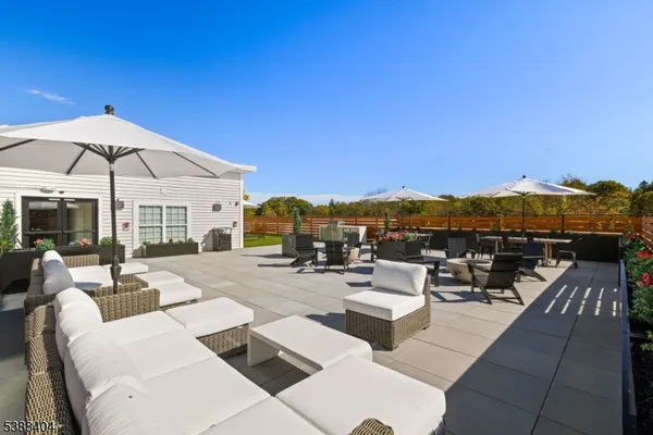 a view of a patio with couches potted plants and a table