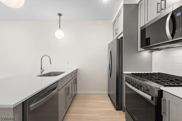a kitchen with stainless steel appliances a sink and a stove
