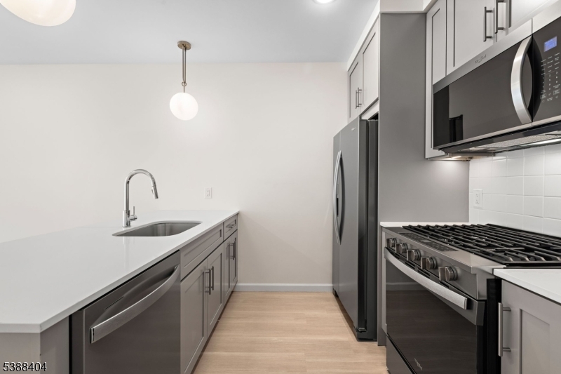 70 Ridgedale Avenue, Unit 204 Morristown, NJ 07960 - Photo 2 of 21 a kitchen with stainless steel appliances a sink and a stove