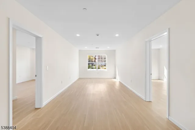 a view of an empty room and a window