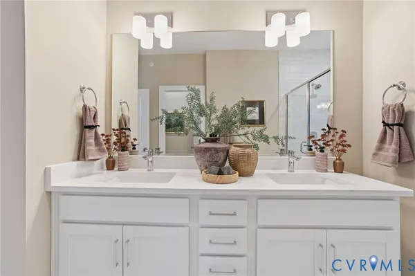 a bathroom with a sink double vanity and a mirror