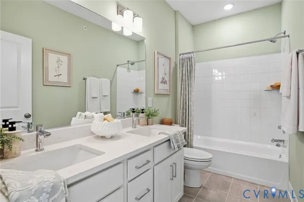 a bathroom with a granite countertop sink a toilet and shower