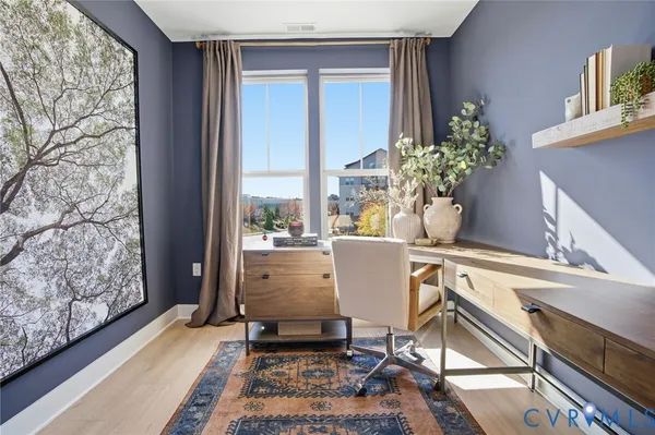 a living room with furniture and a potted plant