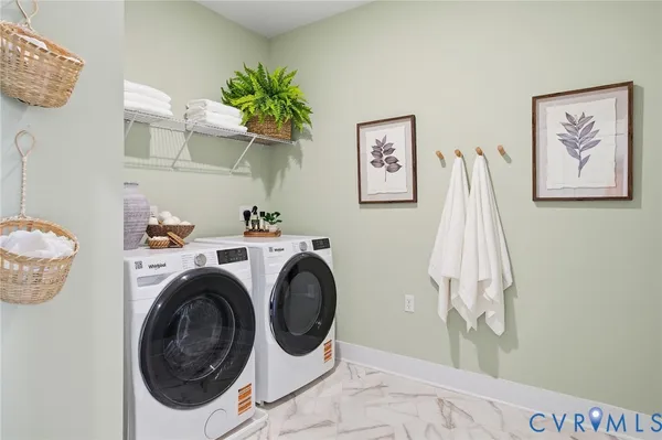 a view of a storage & utility room with a washer dryer