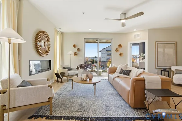 a living room with fireplace furniture and a large window
