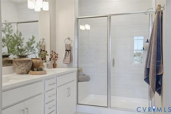 a bathroom with a shower sink and mirror
