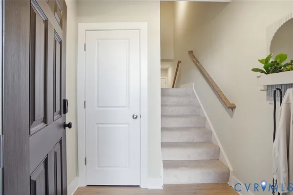 a view of staircase with white walls and a window