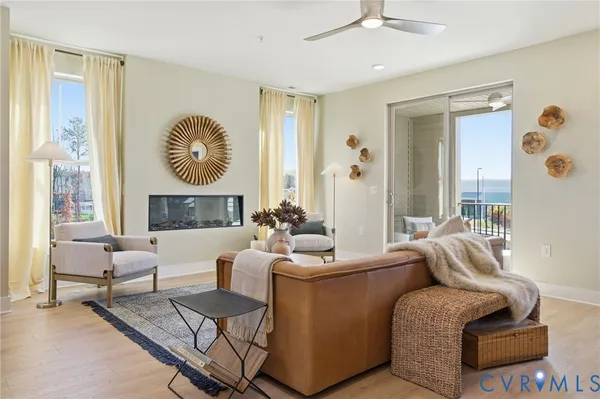 a living room with fireplace furniture and a large window