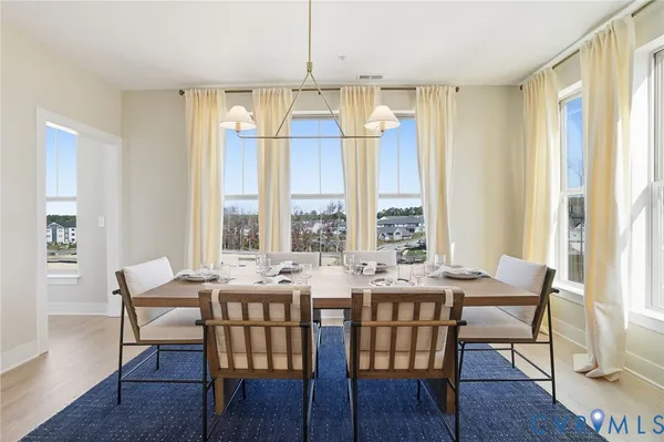 a view of a dining room with furniture and windows