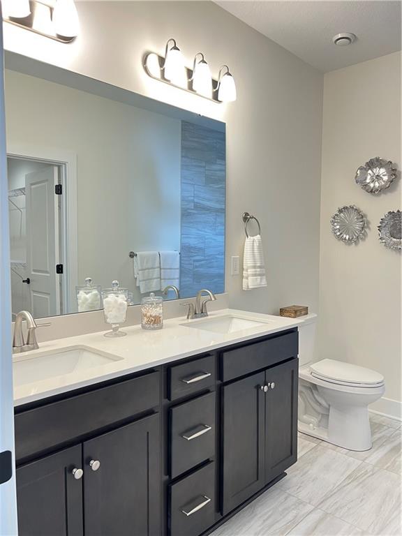 107 Hemingway Lane Coraopolis, PA 15108 - Photo 24 of 32 a bathroom with a double vanity sink and a toilet