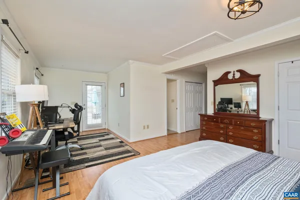 a bedroom with a bed and a dresser in it