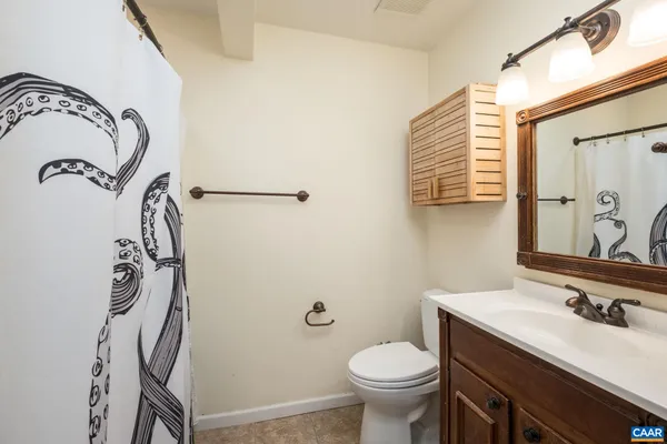 a bathroom with a sink and mirror with toilet