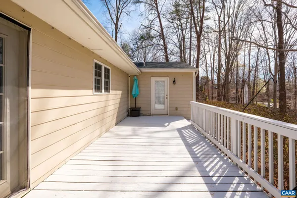 a view of a balcony with wooden floor and fence