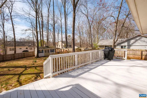 a view of a house with a wooden fence