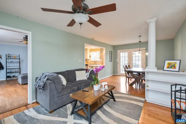 a living room with furniture and a wooden floor
