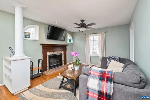 a living room with furniture a flat screen tv and a fireplace