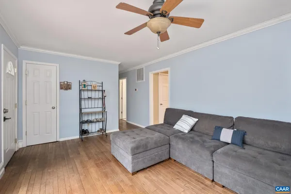 a living room with furniture and a wooden floor