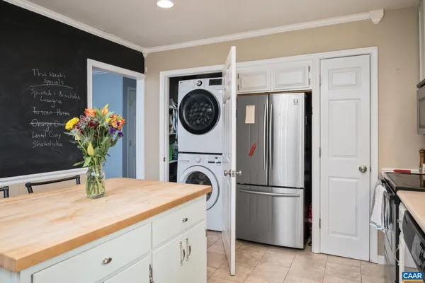 a kitchen with a refrigerator and a sink