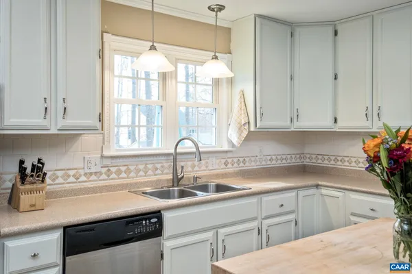 a kitchen with a sink cabinets and window