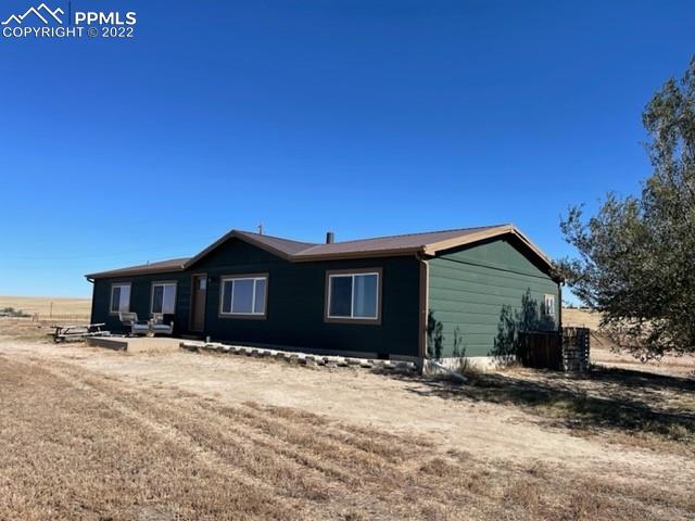 32195 Big Springs Road Yoder, CO 80864 - Photo 4 of 24 a front view of a house with a yard