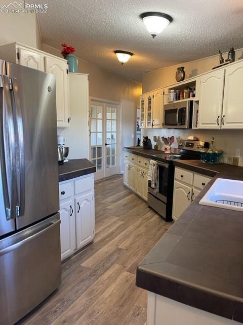 32195 Big Springs Road Yoder, CO 80864 - Photo 9 of 24 a kitchen with stainless steel appliances a refrigerator stove microwave and sink