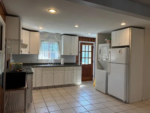 a kitchen with a sink a stove and refrigerator