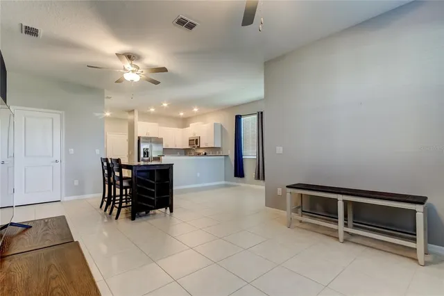 an empty room with furniture and a flat screen tv