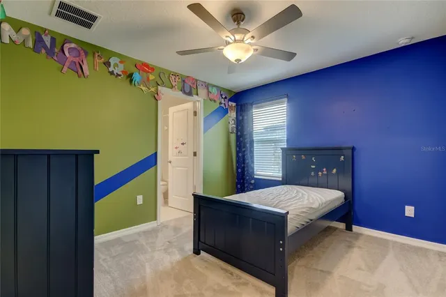 a bed room with a bed and a mirror