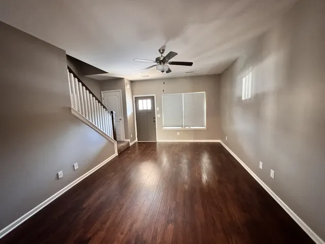 wooden floor in an empty room with a window