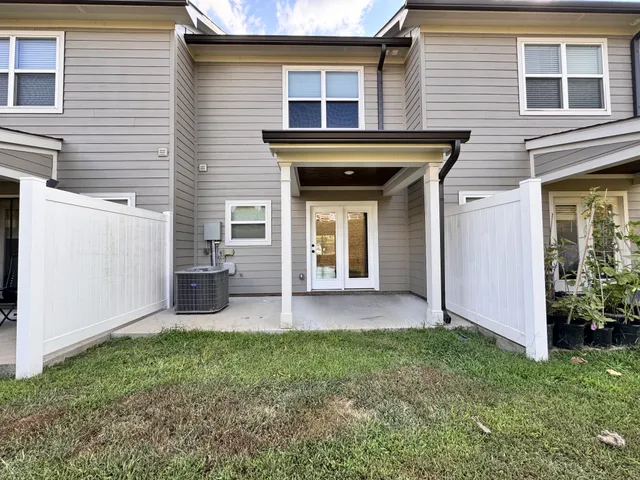 a view of an house with backyard space and a front view of a house