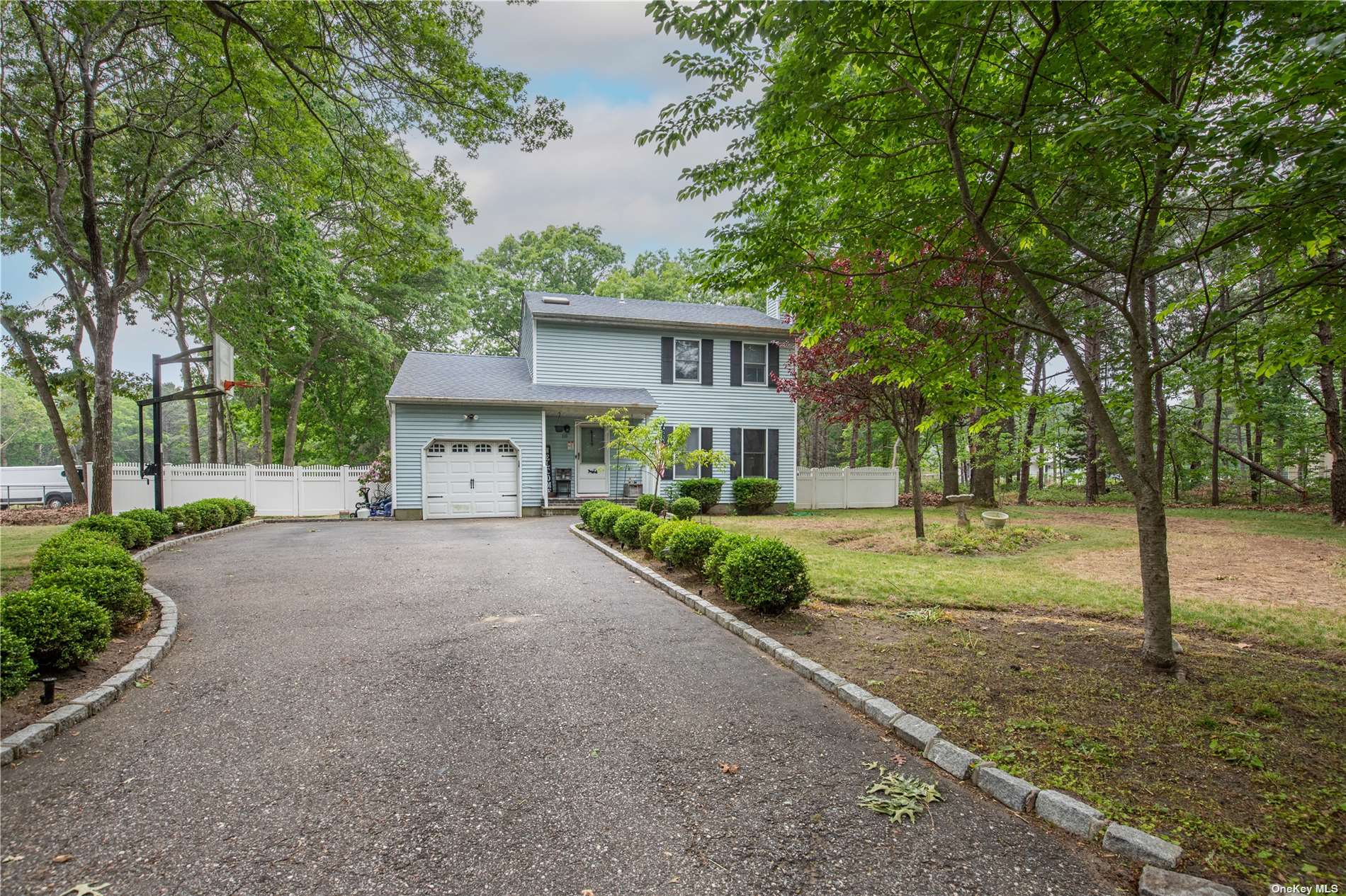 10 Pleasant View Road Ridge, NY 11961 - Photo 1 of 1 a front view of a house with a yard and garage