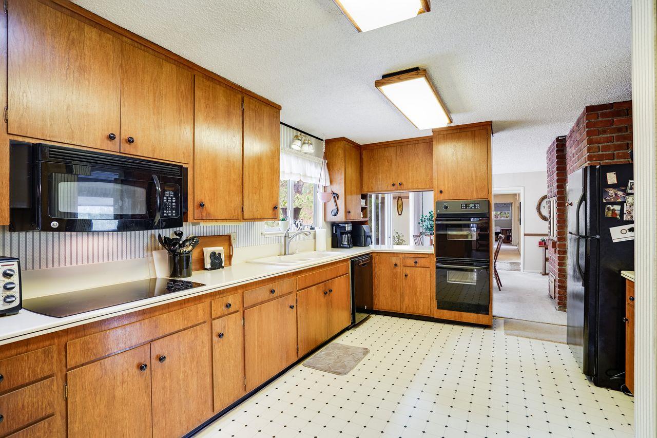 3 Forest Knoll Road Monterey, CA 93940 - Photo 37 of 63 a kitchen with stainless steel appliances kitchen island granite countertop a refrigerator and a stove top oven