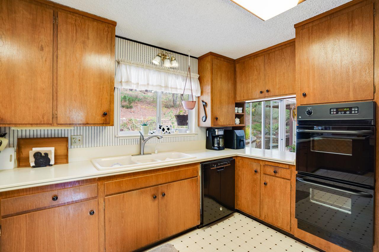 3 Forest Knoll Road Monterey, CA 93940 - Photo 38 of 63 a kitchen with a sink refrigerator and cabinets