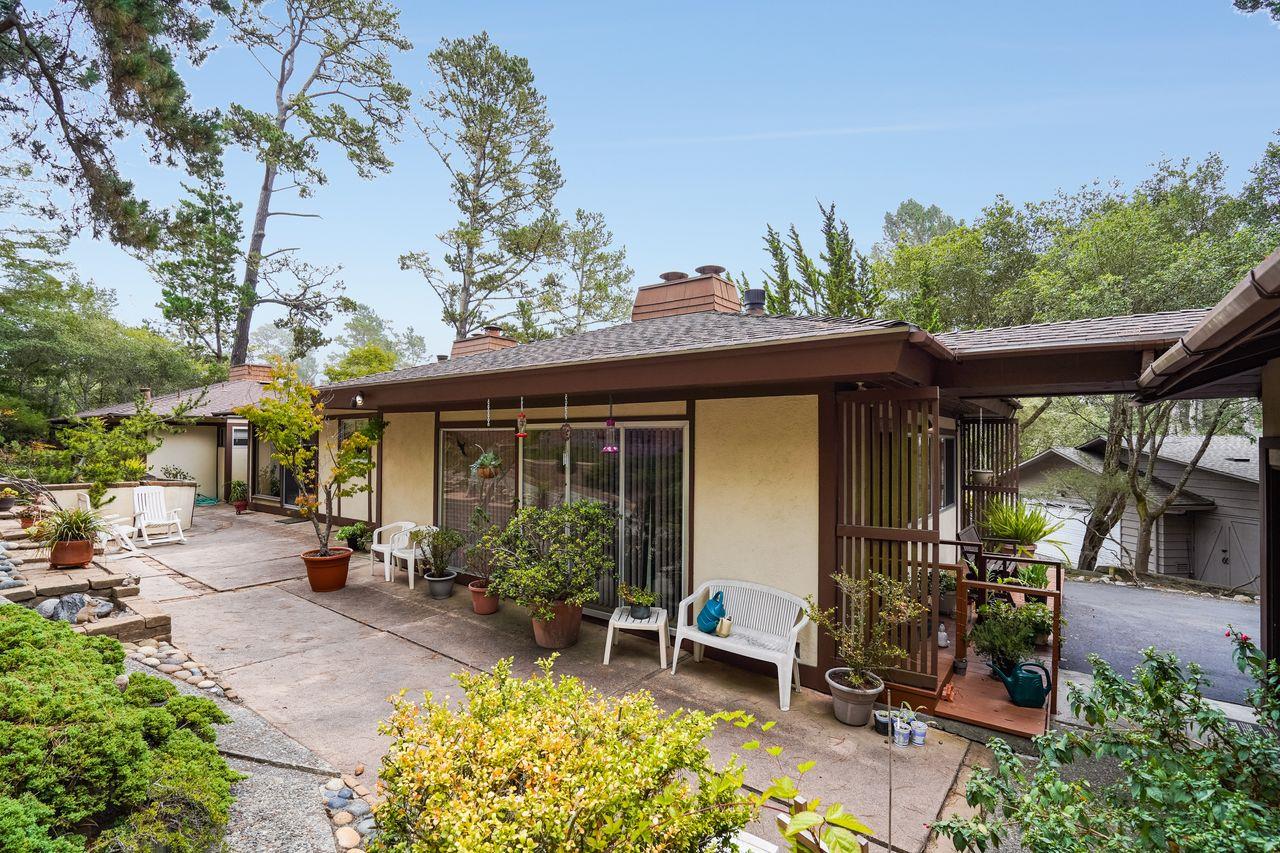 3 Forest Knoll Road Monterey, CA 93940 - Photo 6 of 63 a view of a patio with table and chairs potted plants and large tree