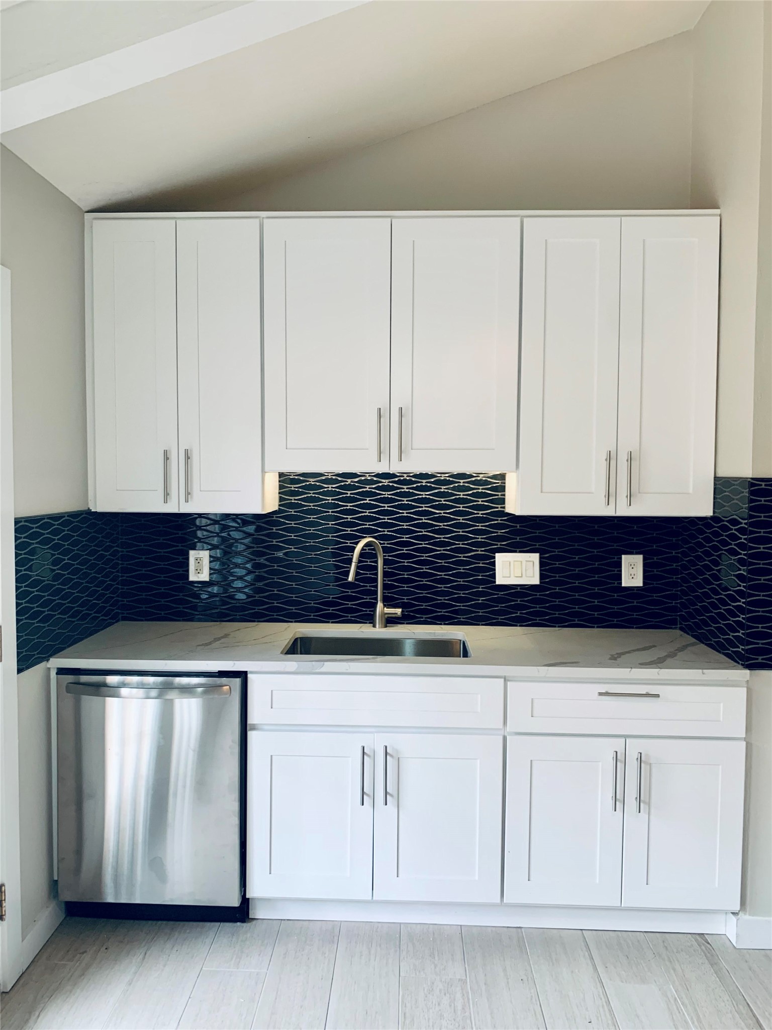6706 Circle S Road, Unit B Austin, TX 78745 - Photo 1 of 18 Crisp white cabinetry pairs with a bold tiled backsplash and modern stainless steel finishes.