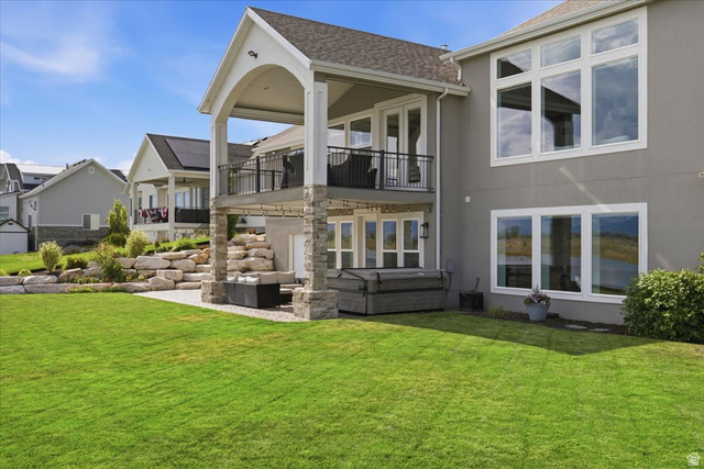 21 Pier Place Tooele, UT 84074 - Photo 97 of 112 Spacious backyard featuring a two-story exterior with a covered patio and upper-level balcony