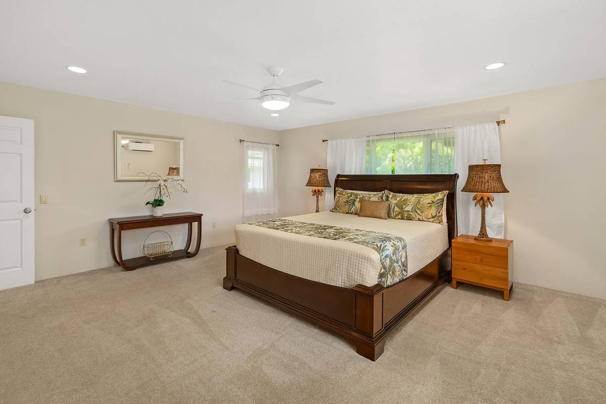 6427 Puupilo Road Kapaa, HI 96746 - Photo 13 of 27 a bedroom with a bed lamp and a window