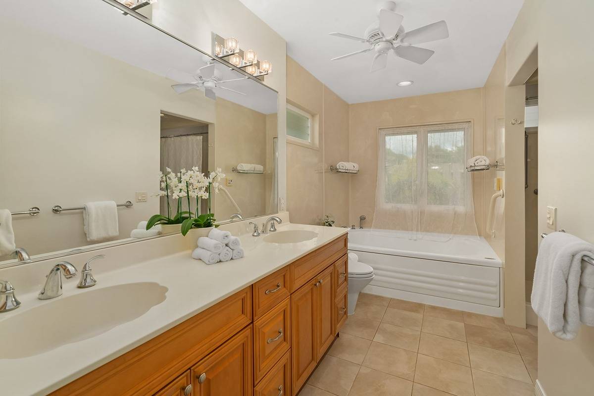 6427 Puupilo Road Kapaa, HI 96746 - Photo 15 of 27 a spacious bathroom with a granite countertop sink mirror and a bathtub