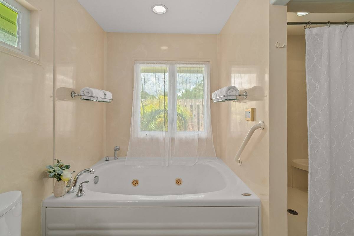 6427 Puupilo Road Kapaa, HI 96746 - Photo 16 of 27 a bathroom with a tub and shower