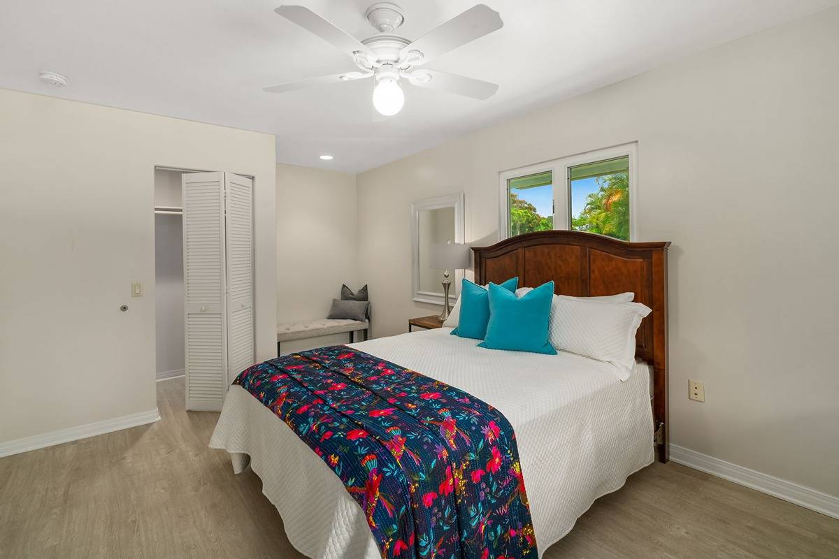 6427 Puupilo Road Kapaa, HI 96746 - Photo 18 of 27 a bedroom with a bed and a chandelier
