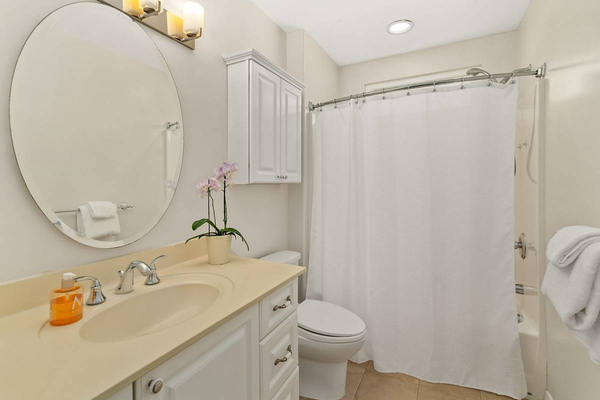 6427 Puupilo Road Kapaa, HI 96746 - Photo 19 of 27 a bathroom with a sink a toilet and shower curtain