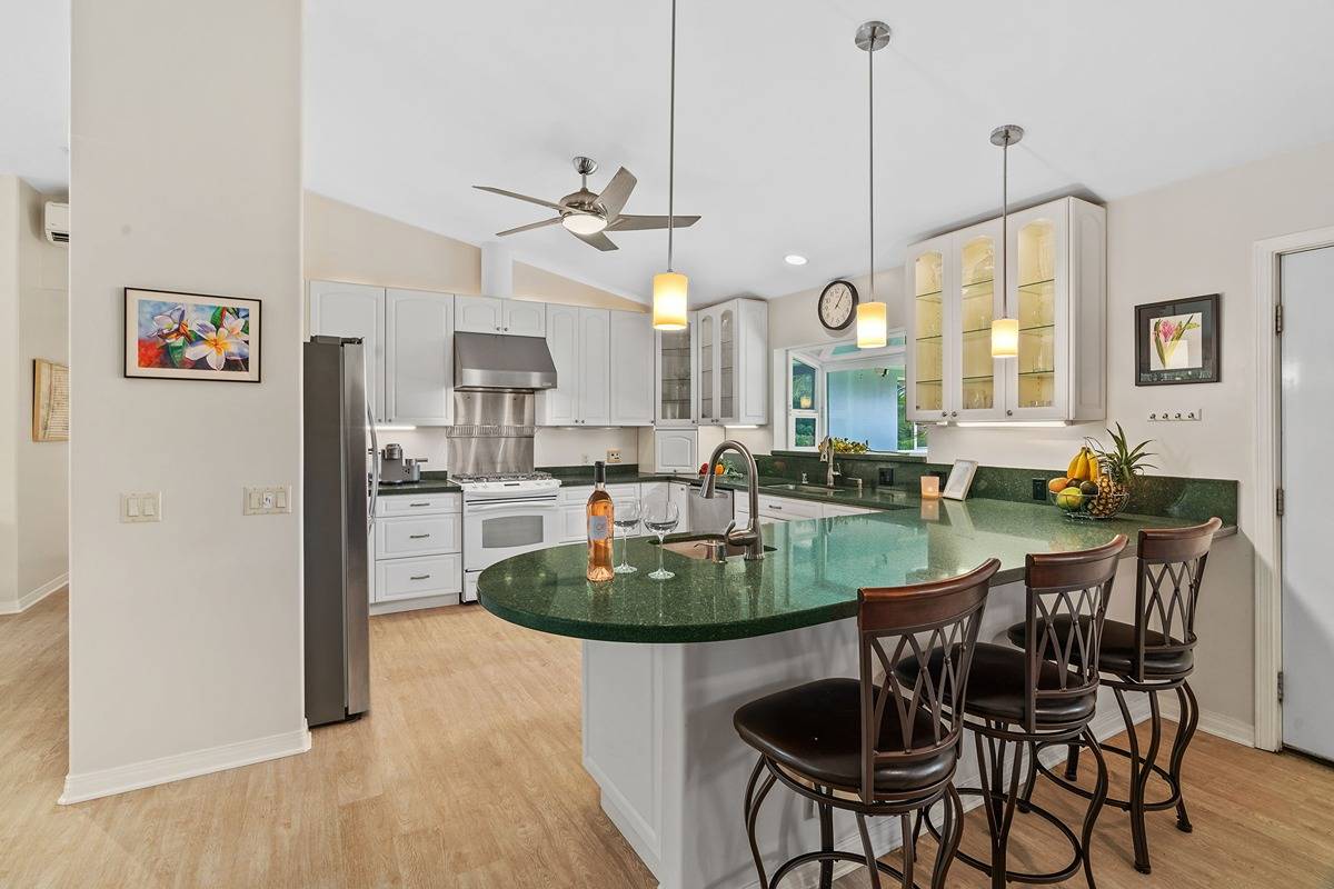 6427 Puupilo Road Kapaa, HI 96746 - Photo 4 of 27 a dining table chairs and a chandelier