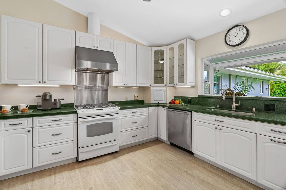 6427 Puupilo Road Kapaa, HI 96746 - Photo 6 of 27 a kitchen with white cabinets and white appliances