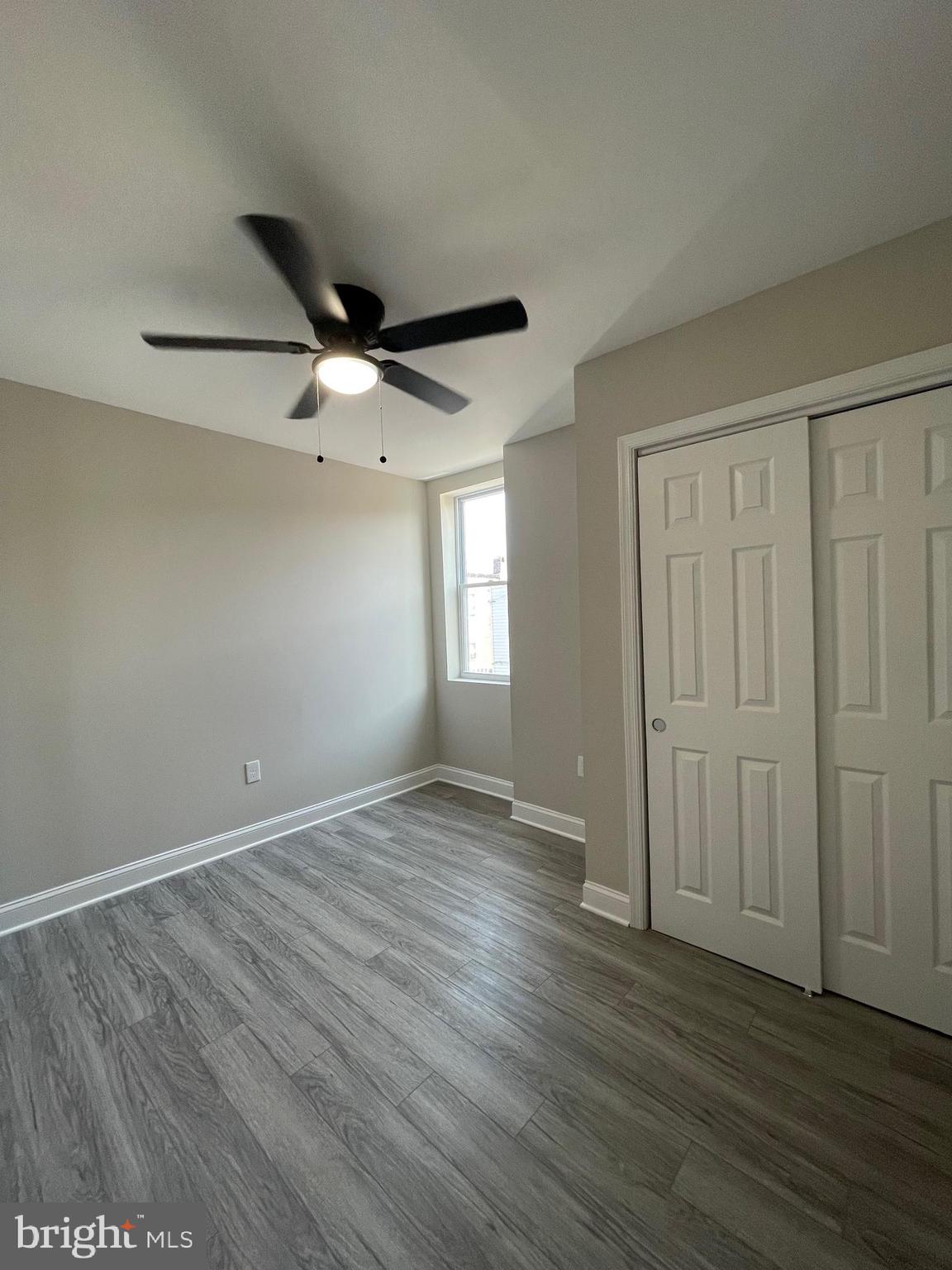1806 East Lanvale Street Baltimore, MD 21213 - Photo 15 of 23 an empty room with wooden floor and windows