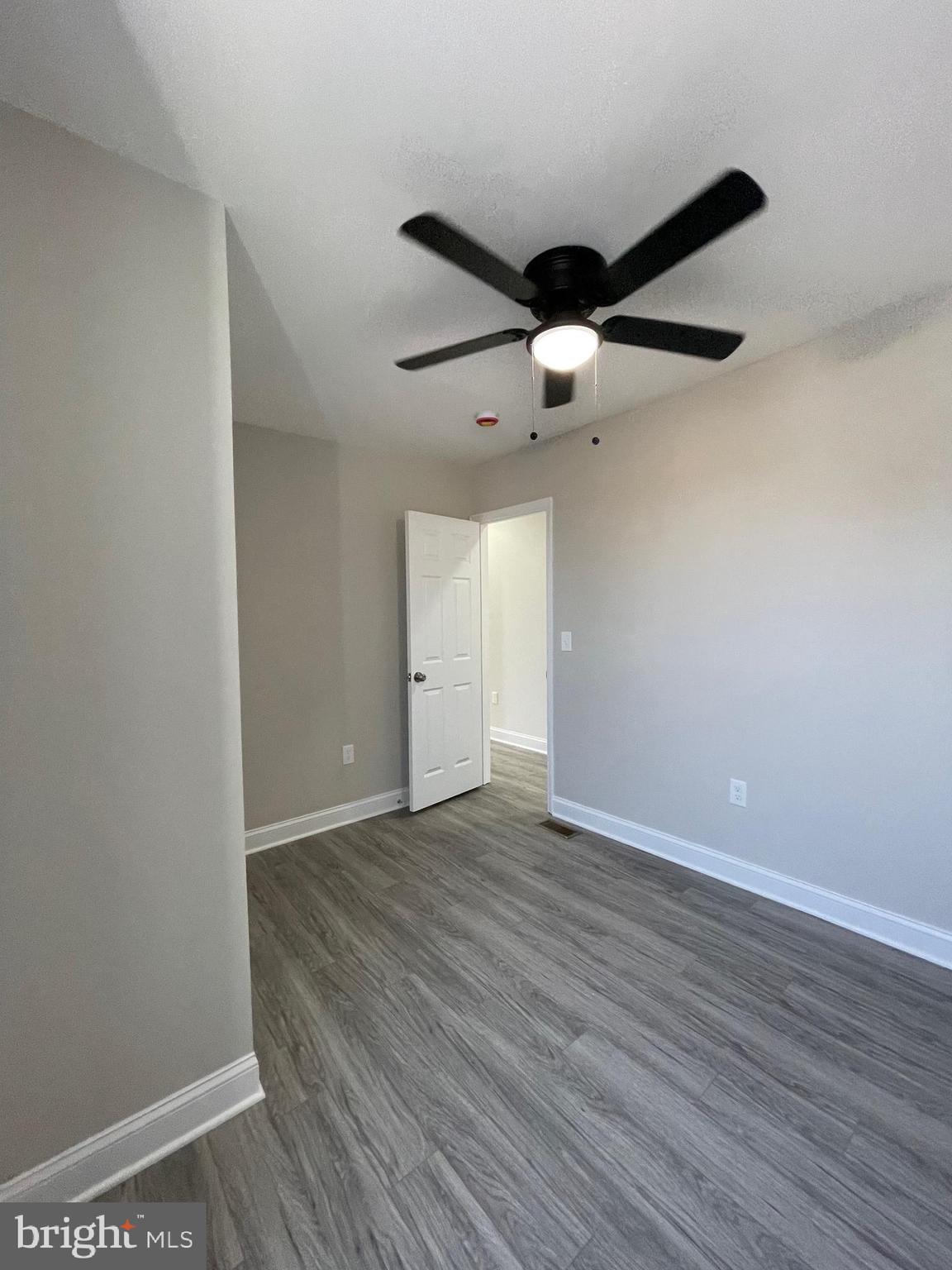 1806 East Lanvale Street Baltimore, MD 21213 - Photo 18 of 23 a view of an empty room with wooden floor