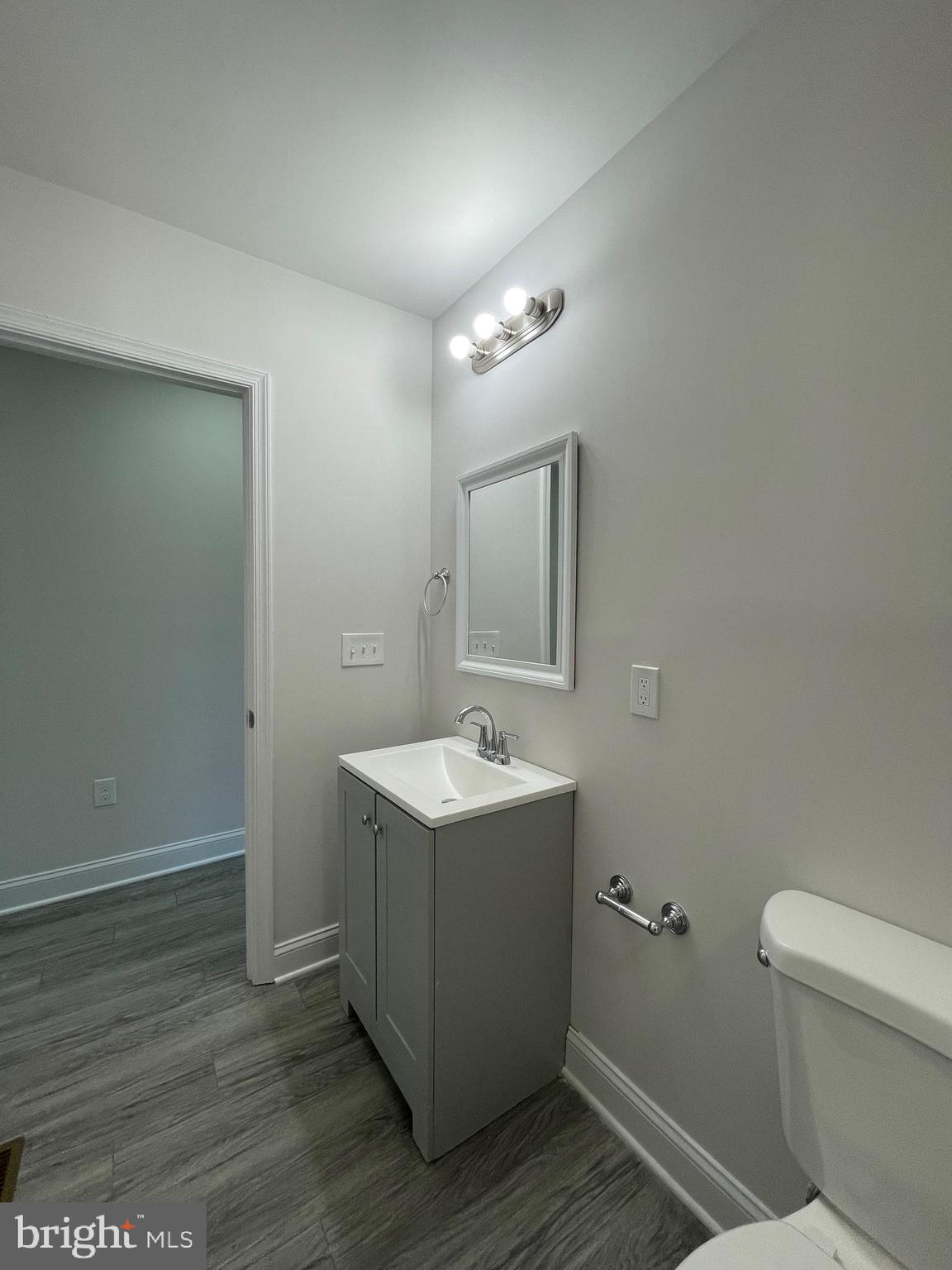 1806 East Lanvale Street Baltimore, MD 21213 - Photo 20 of 23 a bathroom with a sink and mirror with toilet