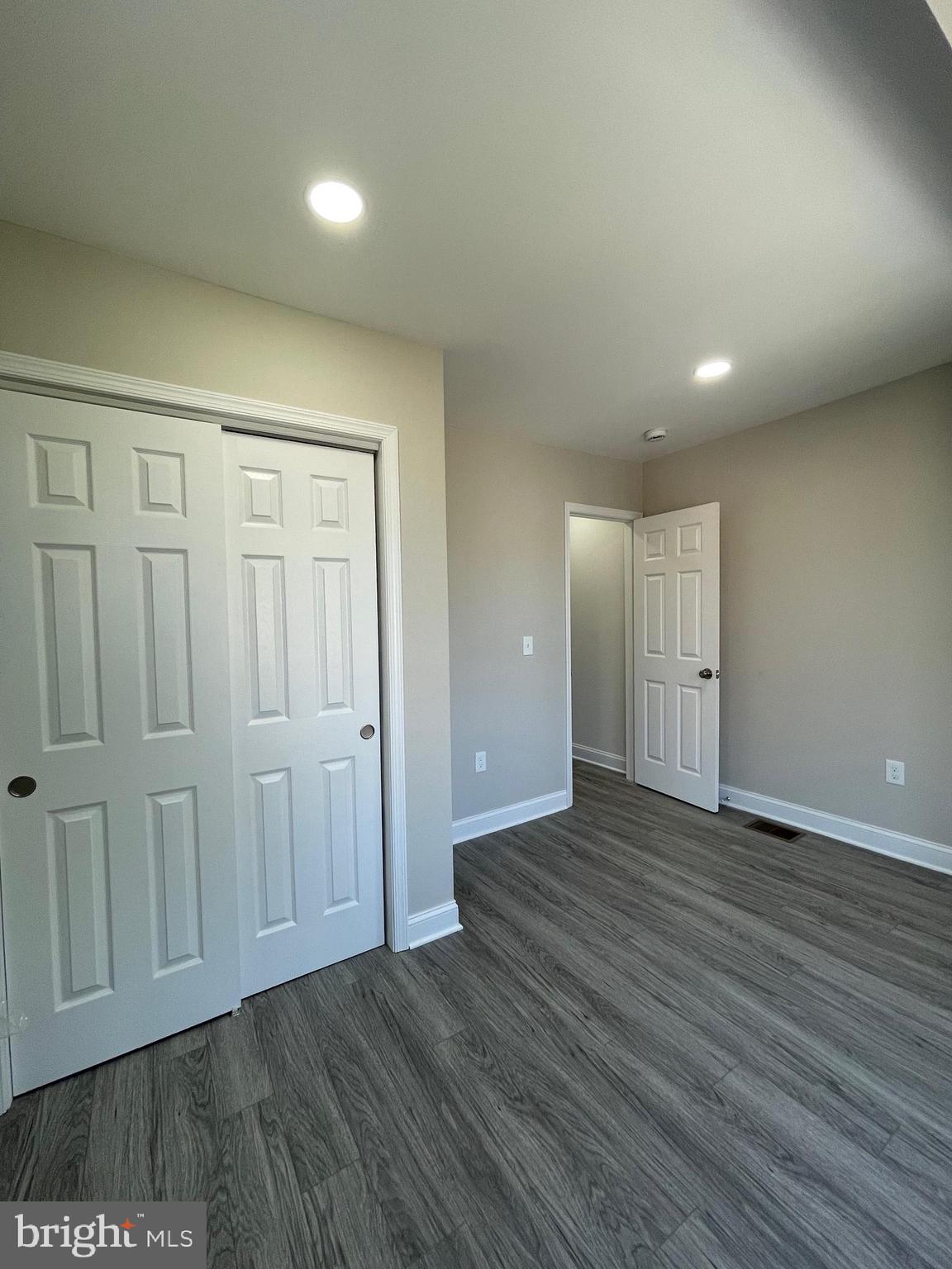 1806 East Lanvale Street Baltimore, MD 21213 - Photo 22 of 23 a view of an empty room with wooden floor