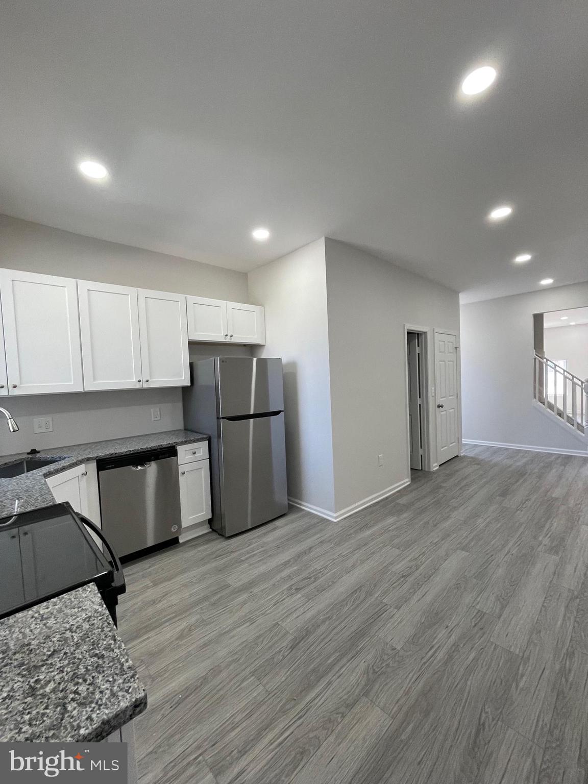 1806 East Lanvale Street Baltimore, MD 21213 - Photo 6 of 23 a kitchen with stainless steel appliances granite countertop a refrigerator sink and cabinets