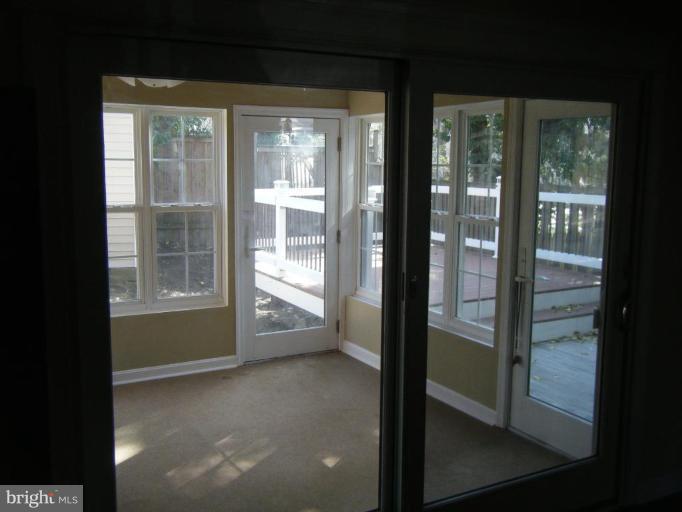5981 Grand Banks Road Columbia, MD 21044 - Photo 8 of 27 View from family room through sunroom to deck