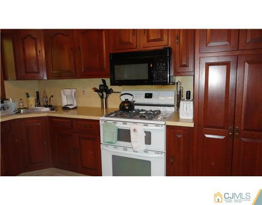 740 Old Raritan Road Edison, NJ 08820 - Photo 2 of 24 a kitchen with a sink cabinets and stainless steel appliances